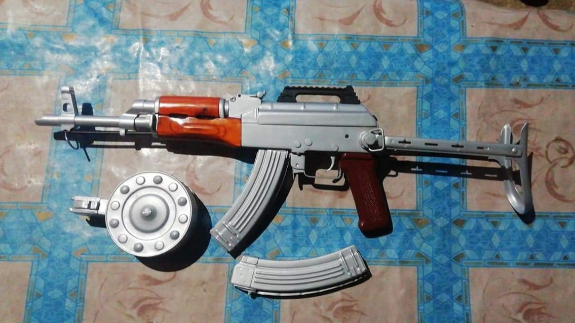 Darra: An AK sub-gun design based off an AKMS with a matte nickel finish and faux drum magazine (source social media) Darra: An AK sub-gun design based off an AKMS with a matte nickel finish and faux drum magazine (source social media)